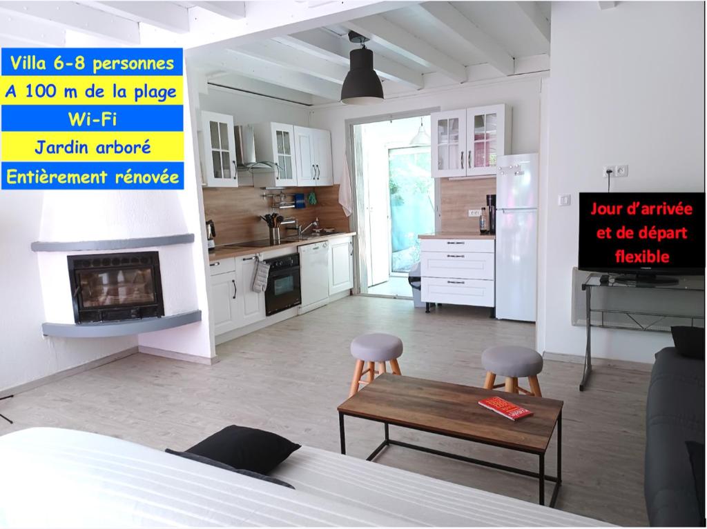a kitchen with a table and chairs in a room at Entre mer et garrigue in Saint Pierre La Mer