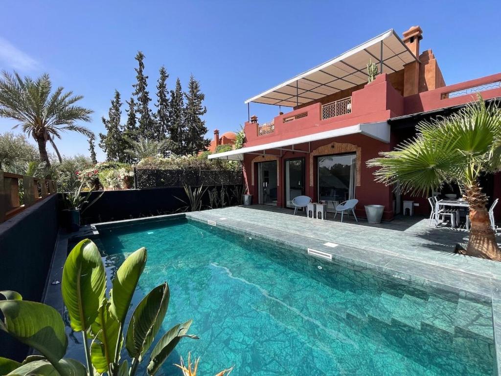 a house with a swimming pool in front of a house at La Villa 2A in Marrakesh