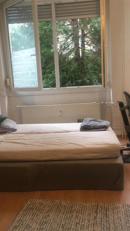 a bed sitting in a room with a window at Dream of Imaginations in the Heart of the City in Berlin