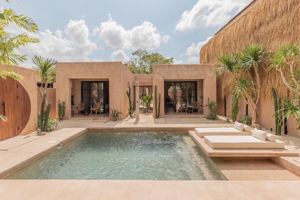 an exterior view of a house with a swimming pool at Abu X Abu in Canggu