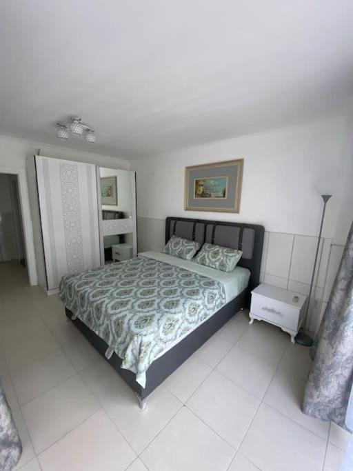 a bedroom with a bed in a white room at Апартаменты 1+1 с выходом на бассейн in Kemer