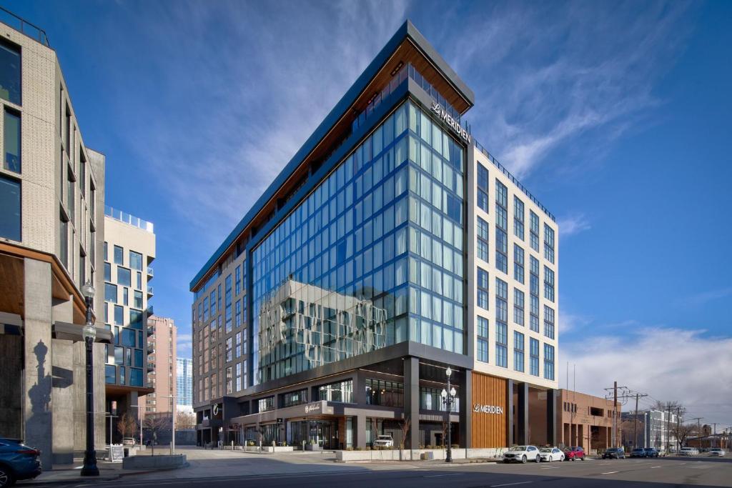 a tall building with glass windows on a city street at Le Méridien Salt Lake City Downtown in Salt Lake City