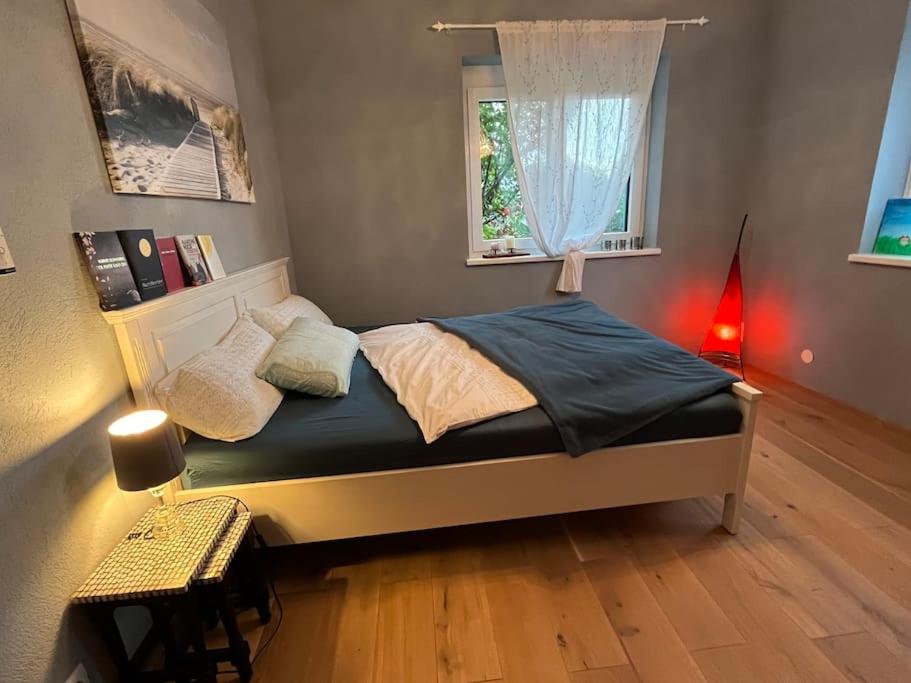 a small bedroom with a bed with a window at Landhaus Apartment in Pettnau