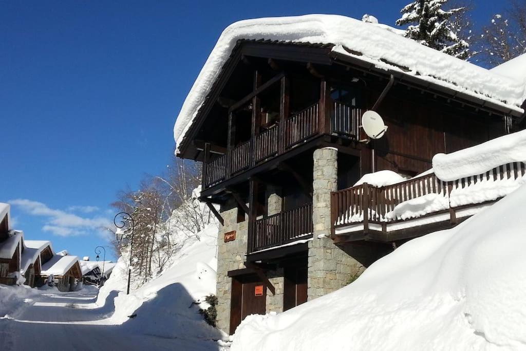 Cette cabane en rondins recouverte de neige dispose d'un balcon. dans l'établissement Chalet Fegguese - 4 bedroom chalet with hot-tub, à Sainte-Foy-Tarentaise