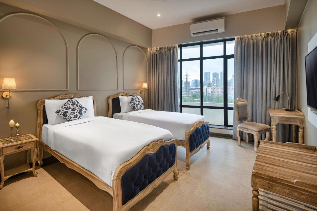 Postel nebo postele na pokoji v ubytování Arnna Hotel - Goregaon