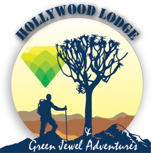 a man walking on a hill next to a tree at Hollywood Lodge in Steinkopf