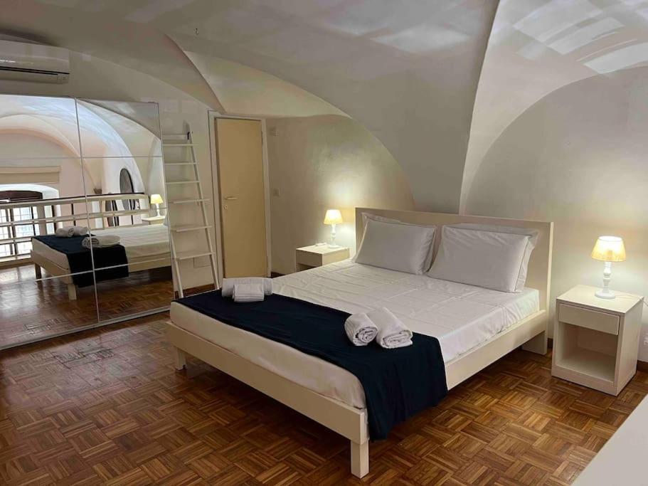 1 dormitorio con 1 cama y 2 toallas blancas en Ponte Vecchio cozy Oltrarno apartment, en Florencia