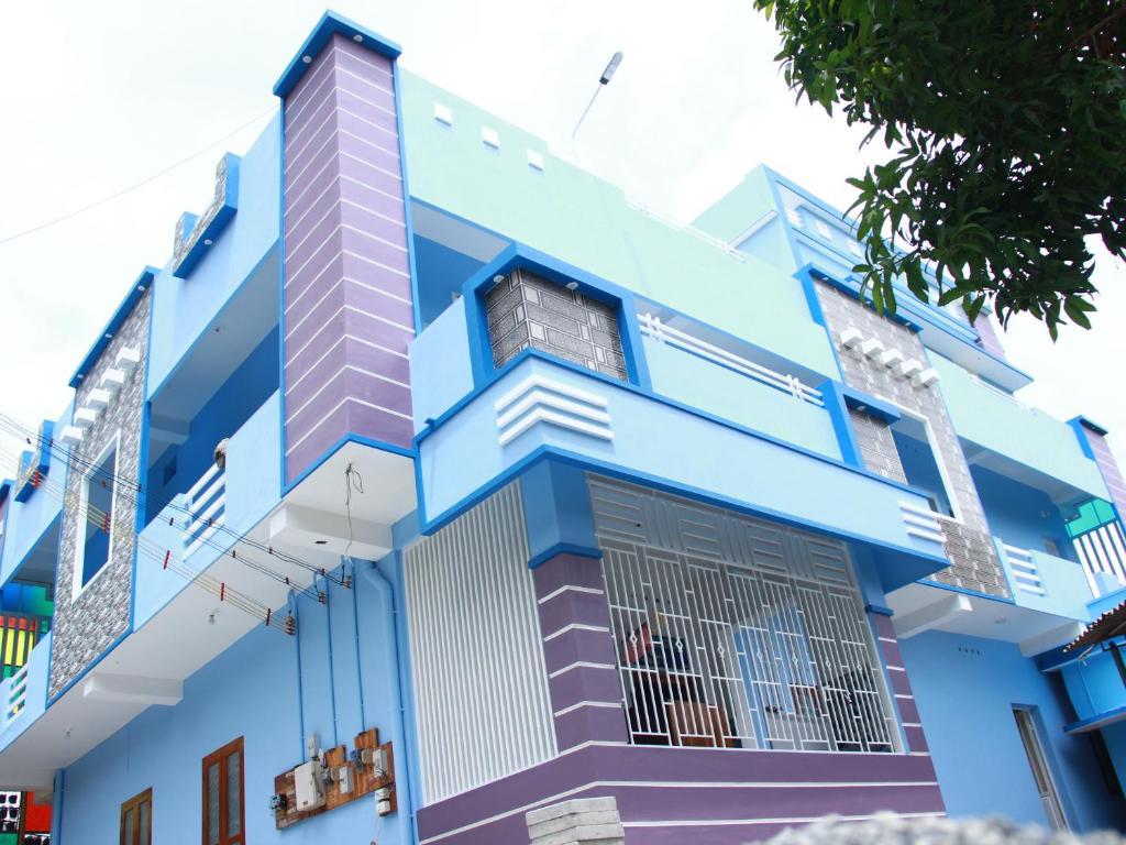a blue building with a window at Countryside inn in Tiruvankod