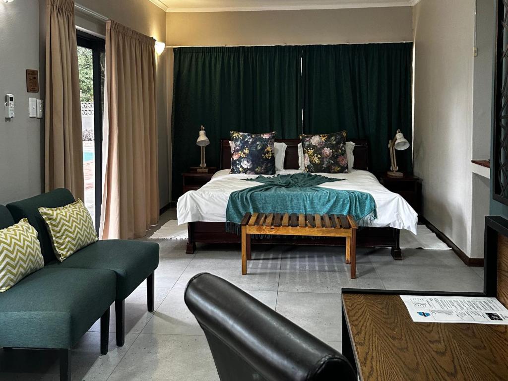 a bedroom with a bed with a green curtain at 1020 Sehudi Guesthouse in Jwaneng