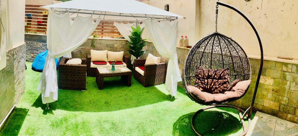 a room with a hammock and a swing at Apartment with a private garden in New Cairo in Cairo