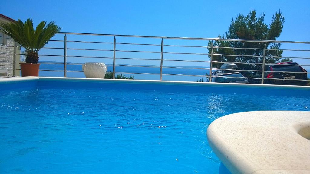 a swimming pool with blue water in a house at Villasanta De Luxe Apartments with Pool in Marusici 