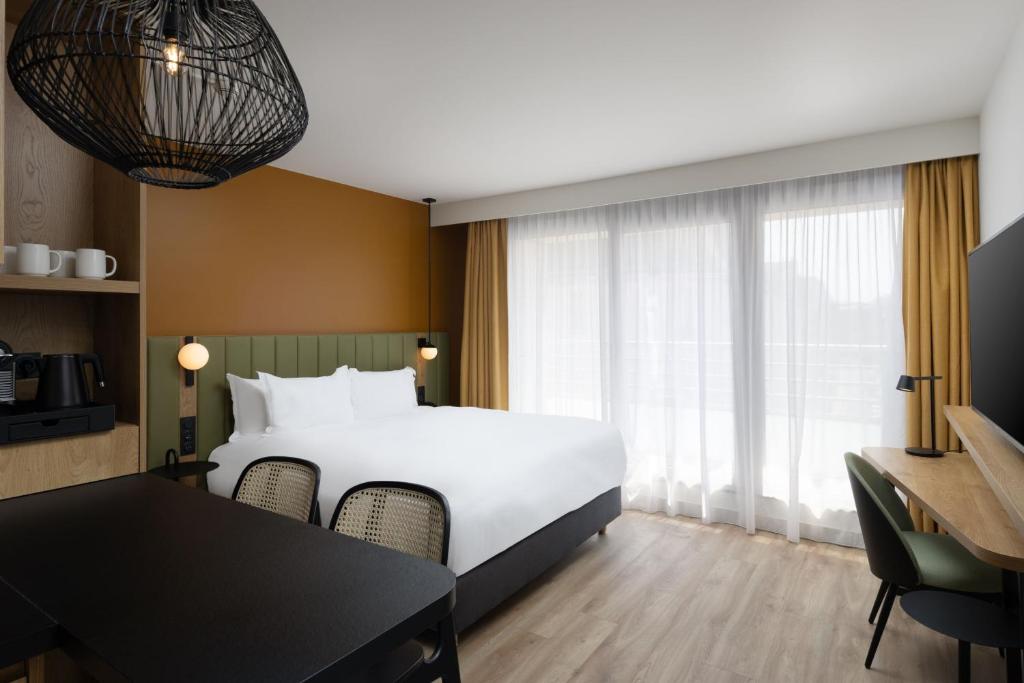 a hotel room with a bed and a table and chairs at Residence Inn by Marriott Paris Didot Montparnasse in Paris
