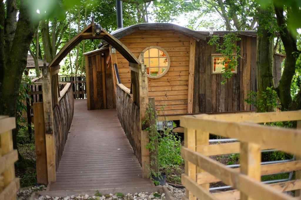 a wooden bridge leading to a tree house at Tree House in Thirsk