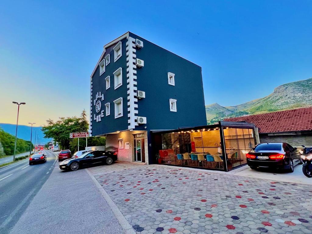 a building with cars parked in front of it at Hotel & Spa Villa Luxe in Mostar