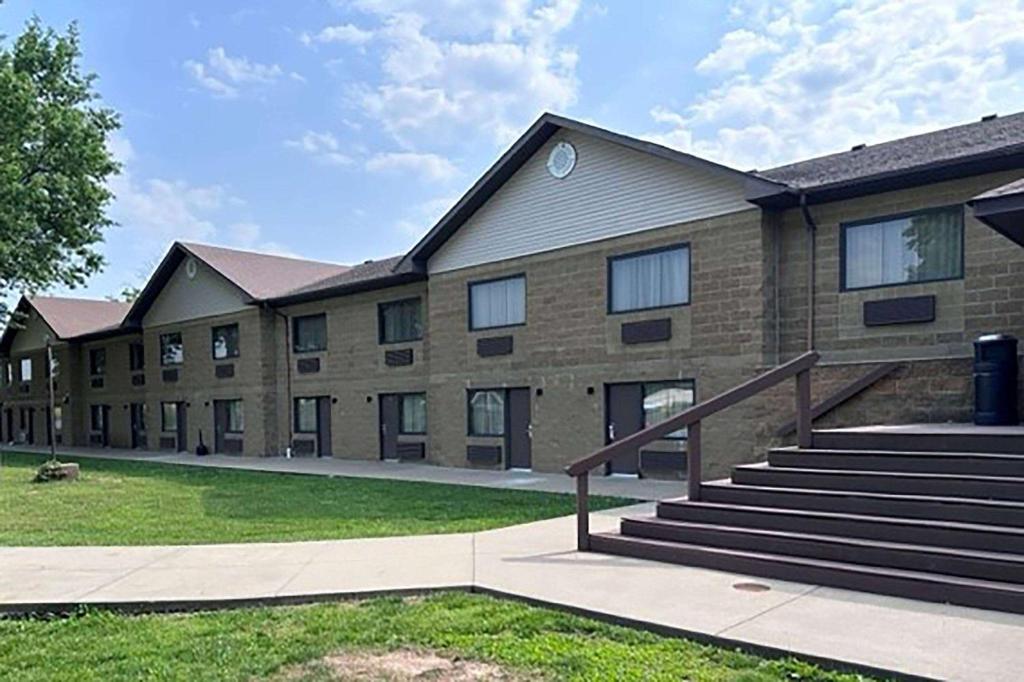 a large brick building with stairs in front of it at Baymont Inn and Suites by Wyndham Farmington, MO in Farmington