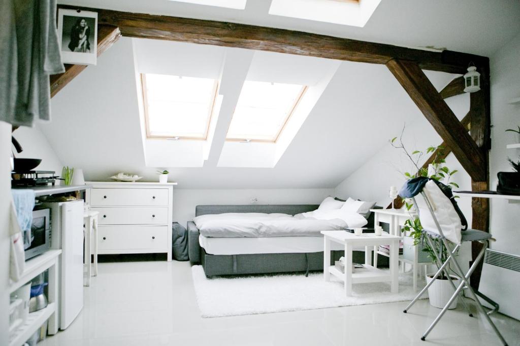 a bedroom with a bed in a attic at Apartamenty Hoża Attic Studio in Warsaw