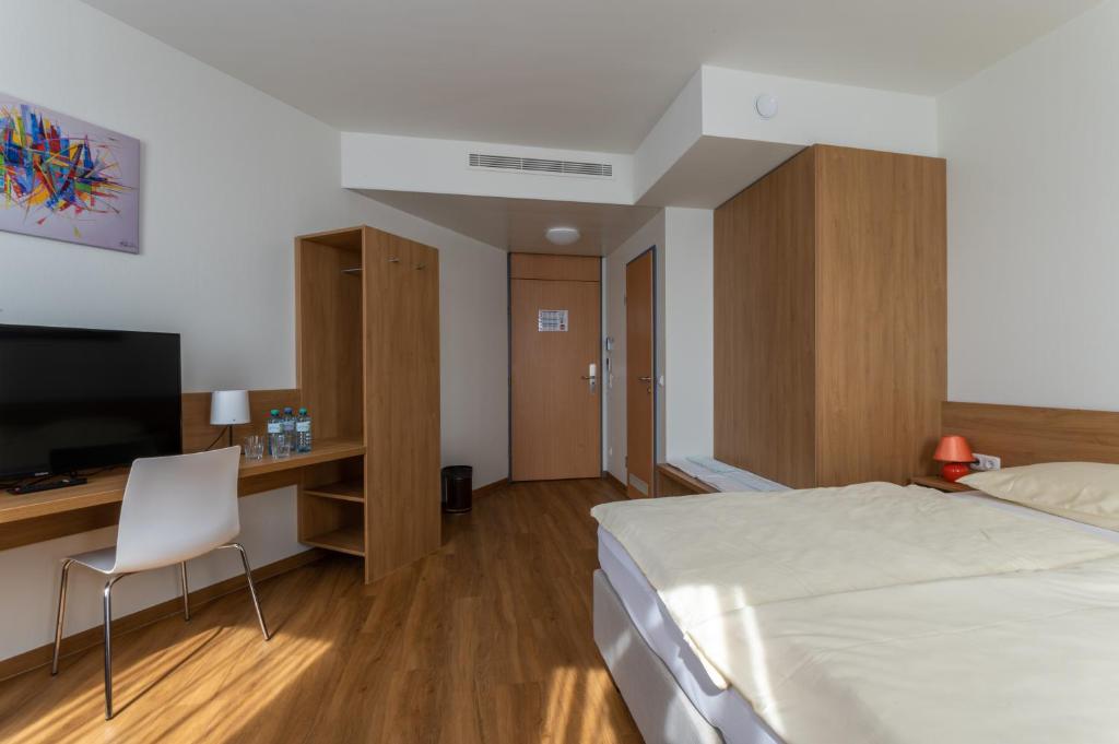 TV a/nebo společenská místnost v ubytování Hotel Sommerhaus Linz