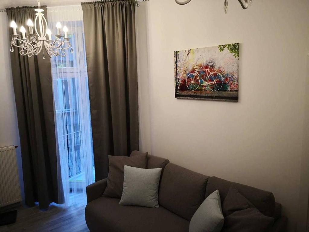 a living room with a couch and a painting on the wall at Z-1 Kraków Old Town O&P ApartFamily in Kraków