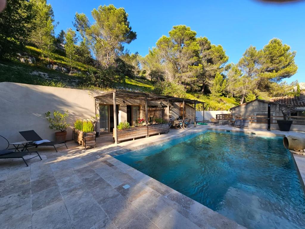 a swimming pool in the backyard of a house at MAS DE LA FADETO in Les Baux-de-Provence