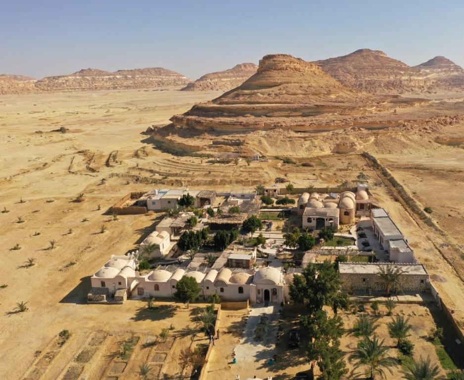 an aerial view of a village in the desert at Moon_Valley_Siwa in Siwa