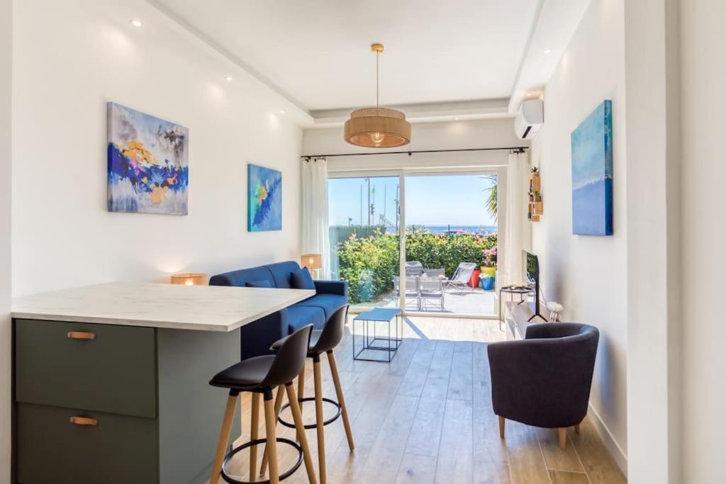 a kitchen with blue chairs and a counter with a table at #43 Design Studio Terrace AC Wifi Sea View 1min Beach in Nice