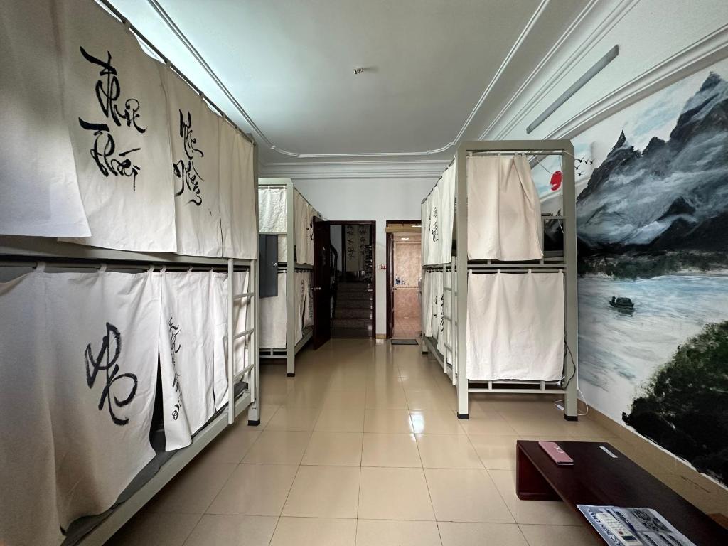a dressing room with a painting on the wall at Home Tea An Yên Dorm in Ho Chi Minh City