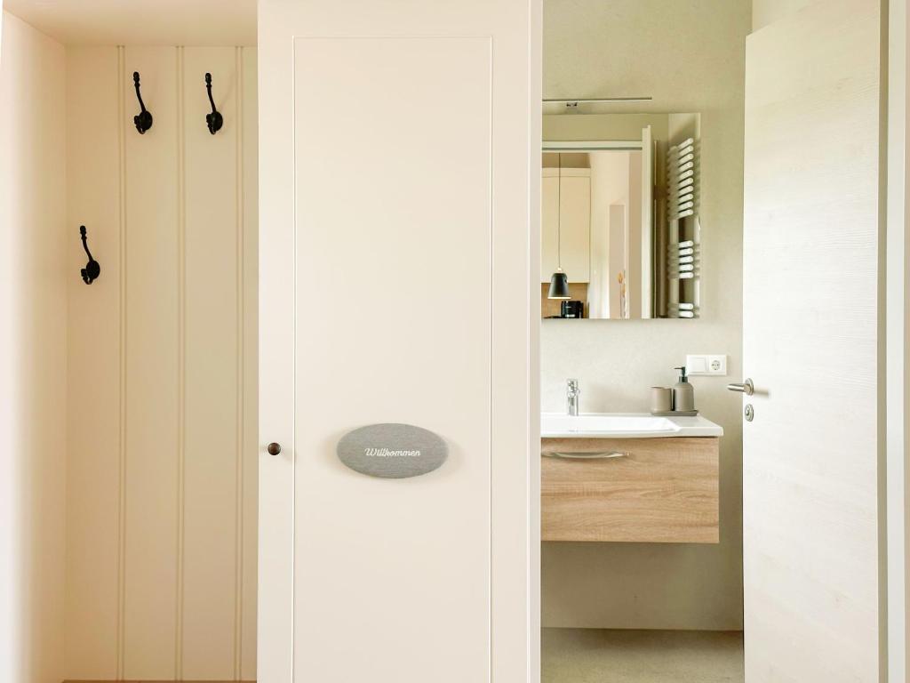 a bathroom with a sink and a mirror at Appartements "Zum Leuchtturm" Hafen Rankwitz Insel Usedom in Rankwitz