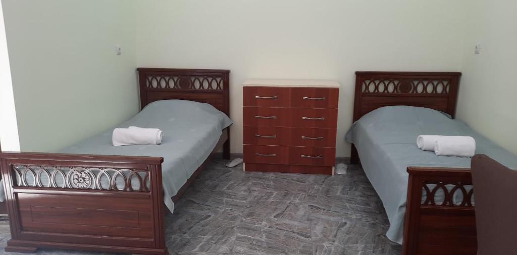 a bedroom with two beds and wooden dressers at new garni 1 in Garni