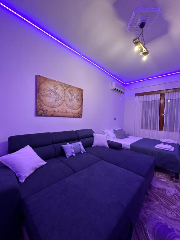 a living room with a couch with purple lighting at Salamis Luxury Escape in Salamís