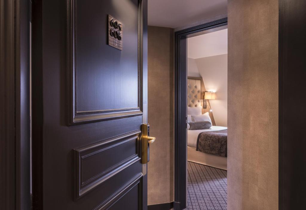 an open door to a bedroom with a bed at La Villa des Ternes in Paris