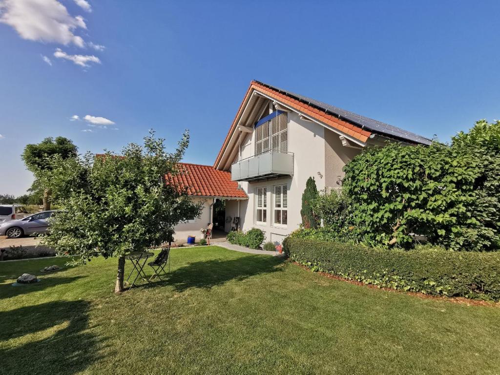 a white house with a tree in the yard at Haus Wagner in Kappel-Grafenhausen