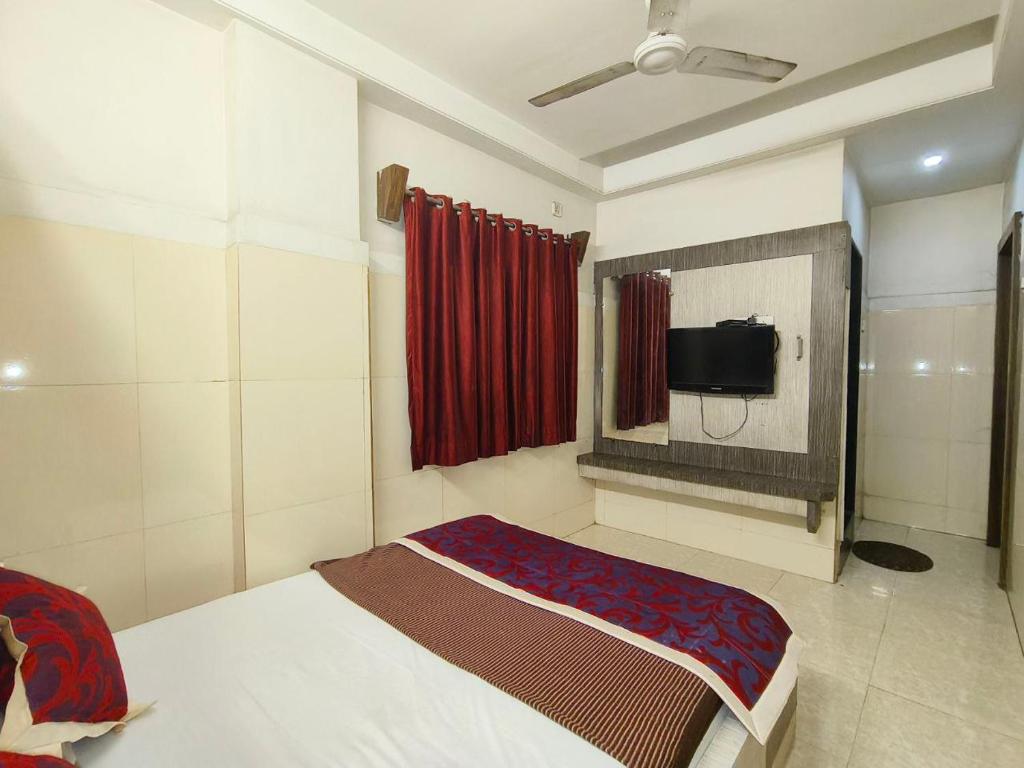 a bedroom with a bed and a tv in it at HOTEL SAI PRABHU INN in Shirdi