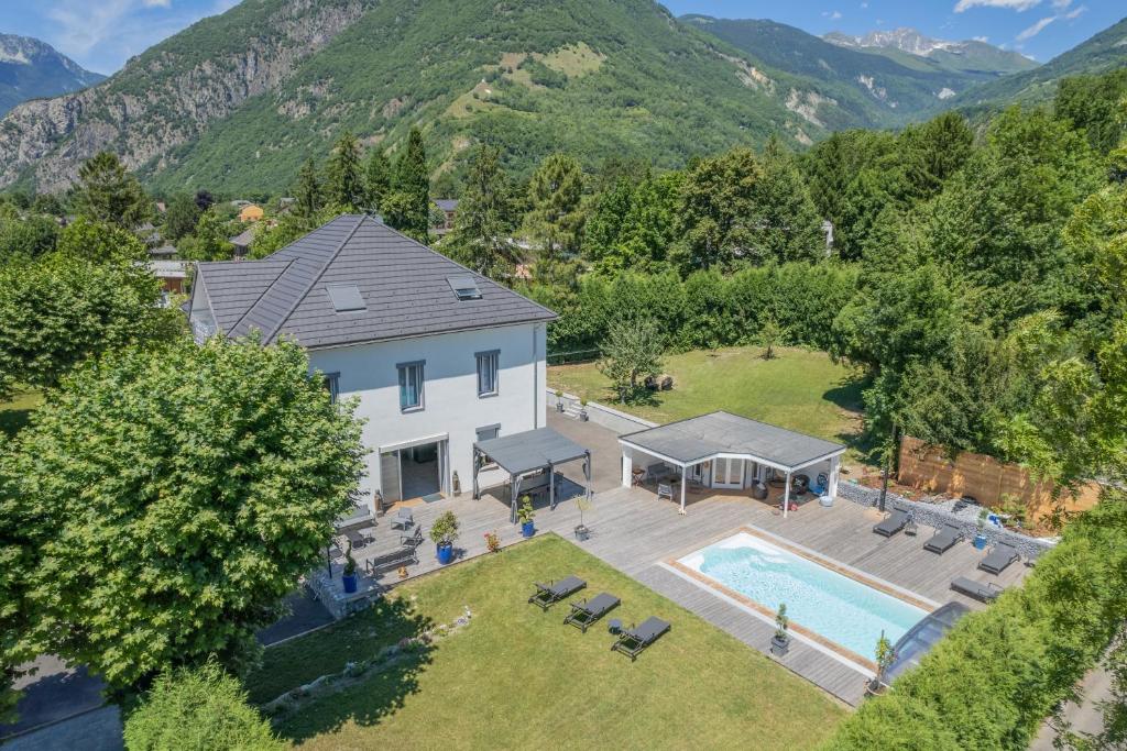 an aerial view of a house with a swimming pool and mountains at le clos grillet in La Chambre