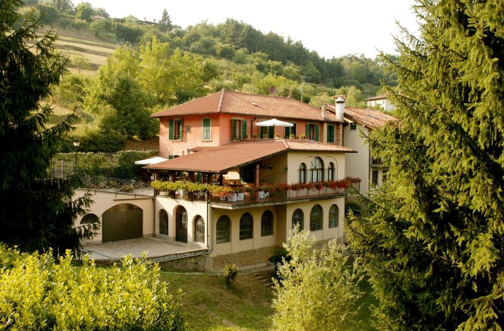 a large house in the middle of a forest at La Valletta Relais in Bergamo