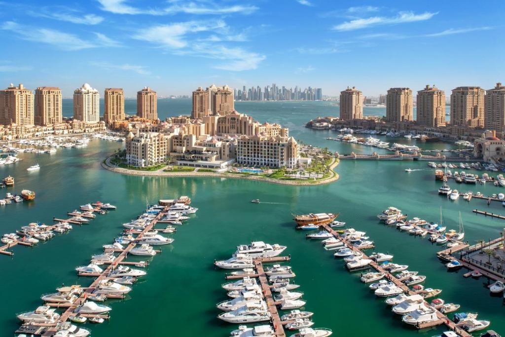 an aerial view of a harbor filled with boats at The St. Regis Marsa Arabia Island, The Pearl Qatar in Doha
