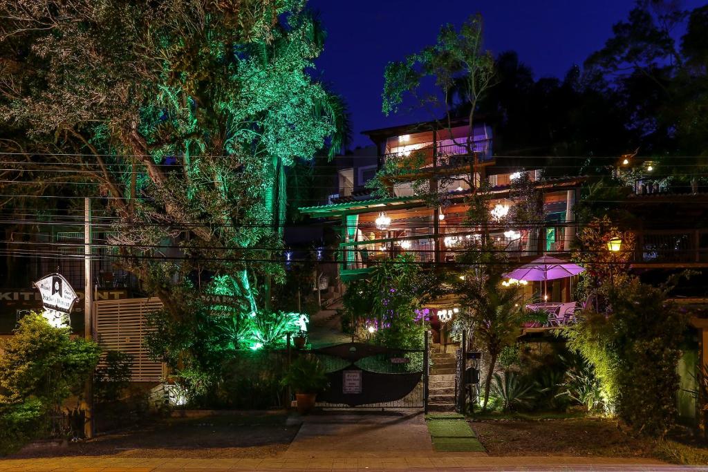 a building lit up at night with green lights at Guest House Isadora Duncan in Florianópolis