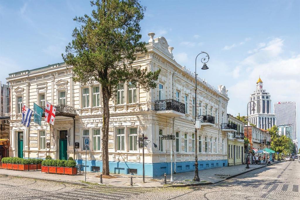 a large white building on a city street at Boulevard Hotel Batumi in Batumi