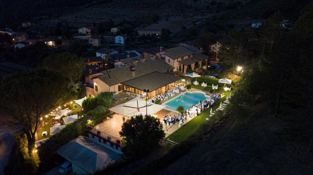 an aerial view of a house with a pool at night at Hotel Ristorante La Fattoria in Spoleto