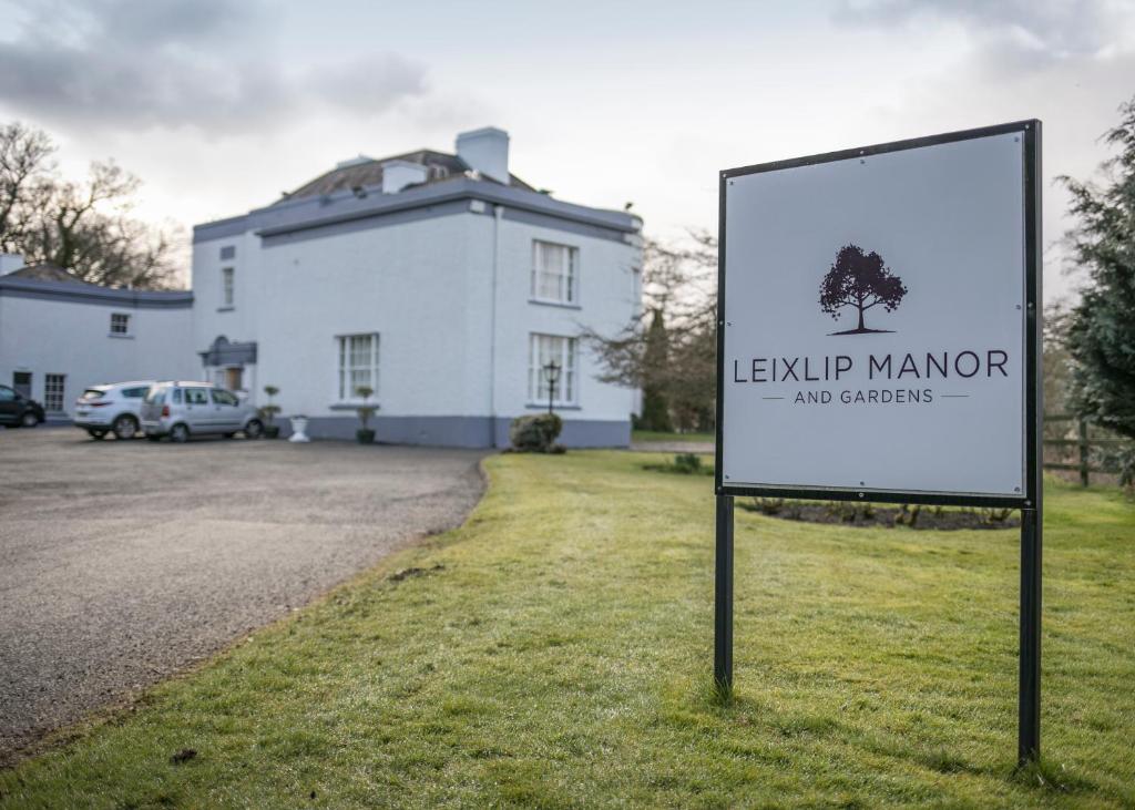 a sign in front of a building with a house at Leixlip Manor Hotel in Leixlip