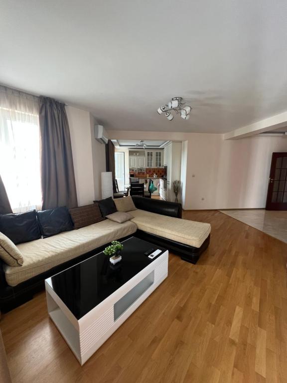 a living room with a couch and a table at Chaika Sea Apartment in Varna City