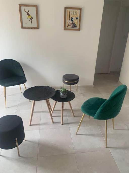 un groupe de chaises et de tables dans une pièce dans l'établissement Logement indépendant -1 chambre -3 lits - 4km du circuit, à Ruaudin