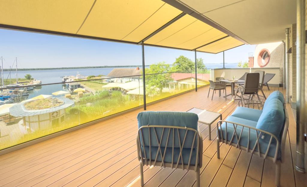 a balcony with a view of the water at Appartements "Zum Leuchtturm" Hafen Rankwitz Insel Usedom in Rankwitz