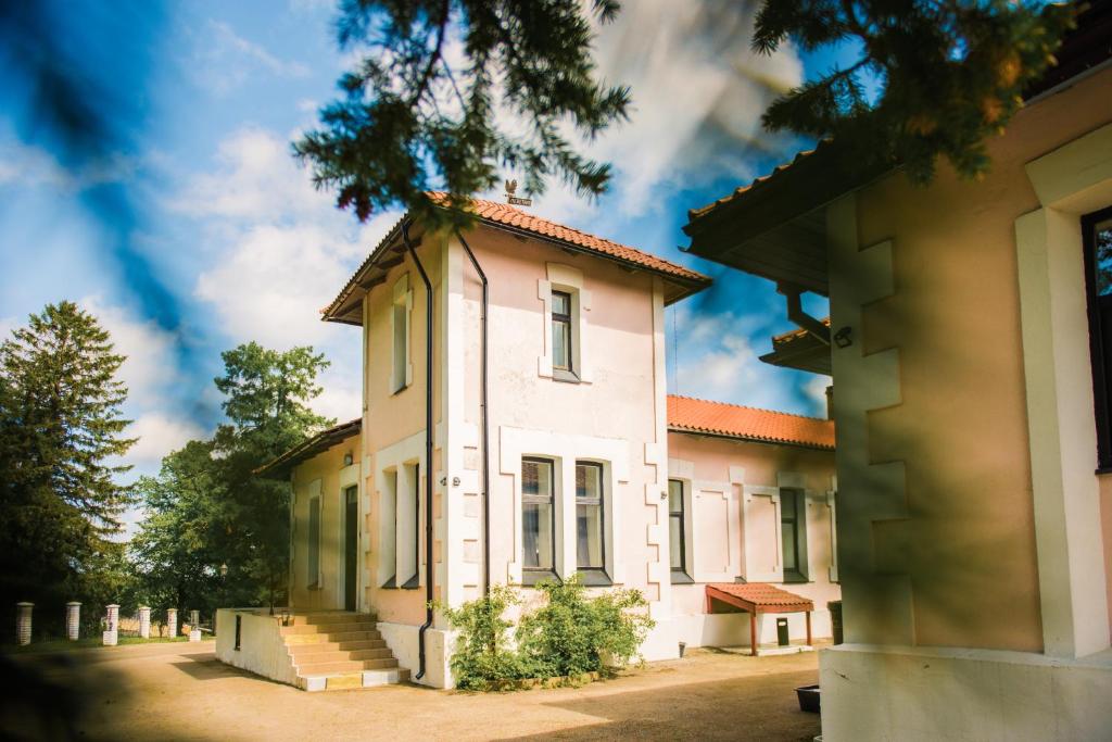 a white building with stairs in front of it at Villa Meretare in Toila