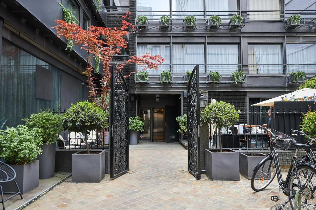 an open door to a building with potted plants at Le Rayz Vendome in Paris