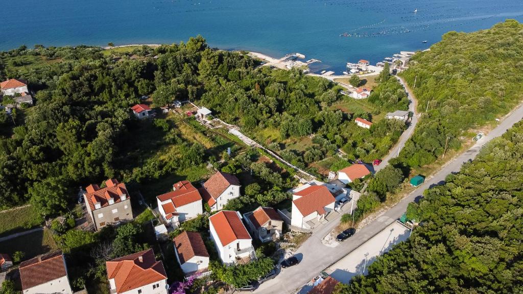 an aerial view of a house on a hill with the water at Apartments Diva in Ston