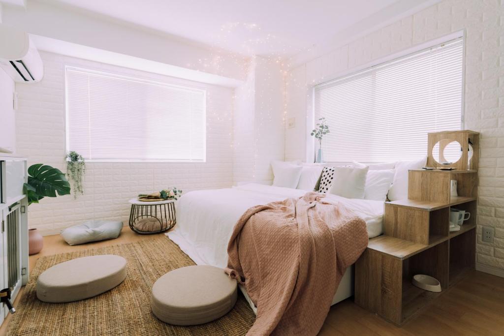 a white bedroom with a bed with a large window at moof Osaka trendy spot Spacious Apt in Osaka