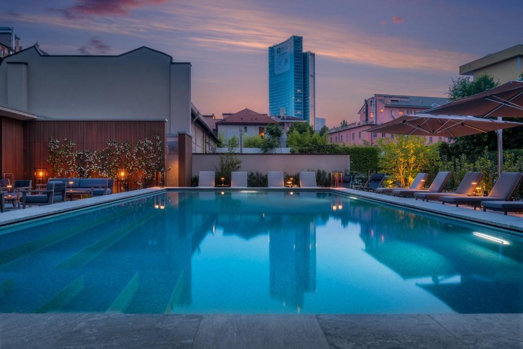 a swimming pool with a city skyline in the background at Crowne Plaza Milan City, an IHG Hotel in Milan