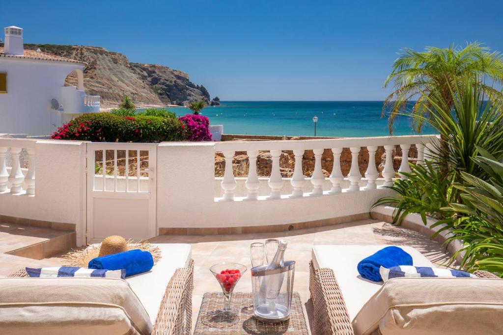 a patio with a table with a view of the ocean at Beachfront Apartment Praia da Luz by Blue Diamond in Alagoas