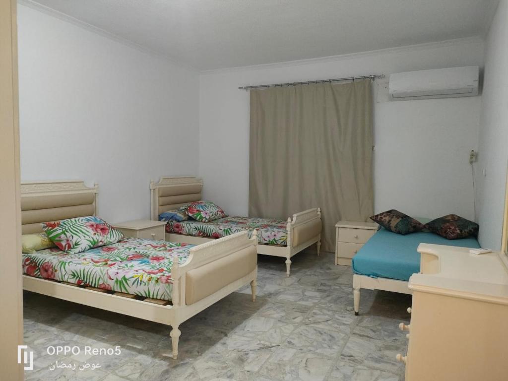 a room with two beds and two beds sidx sidx sidx at North coast in El Alamein