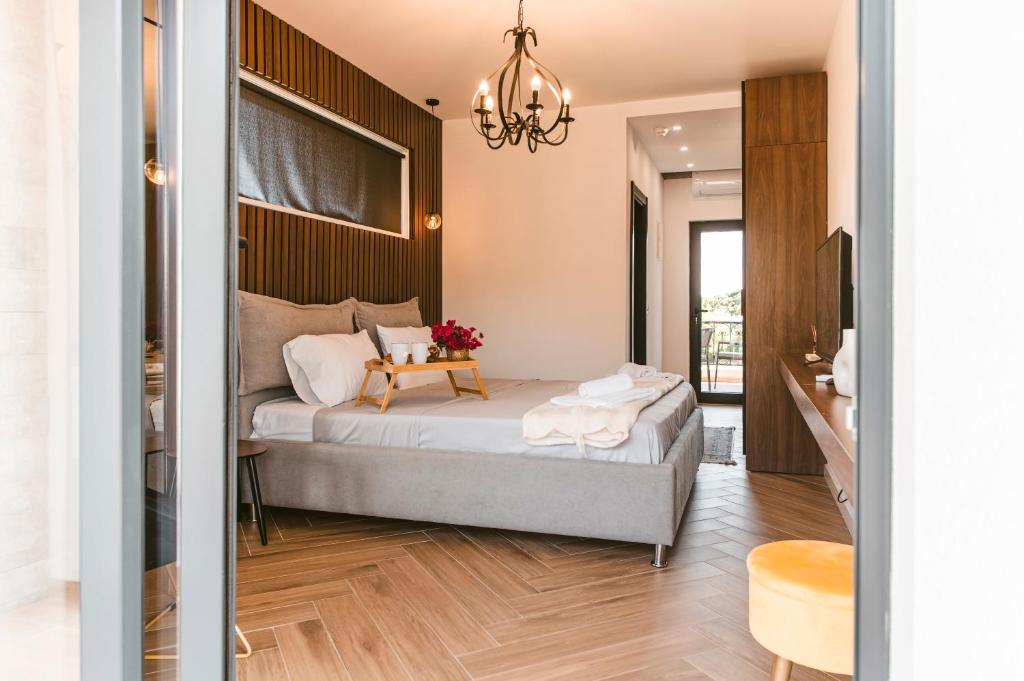 a bedroom with a bed and a table with flowers on it at CAROLEA VILLAS in Ulcinj
